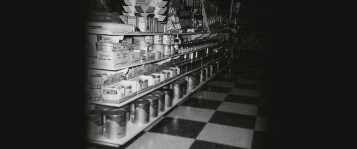 buckets of paint on a shelf on the store.