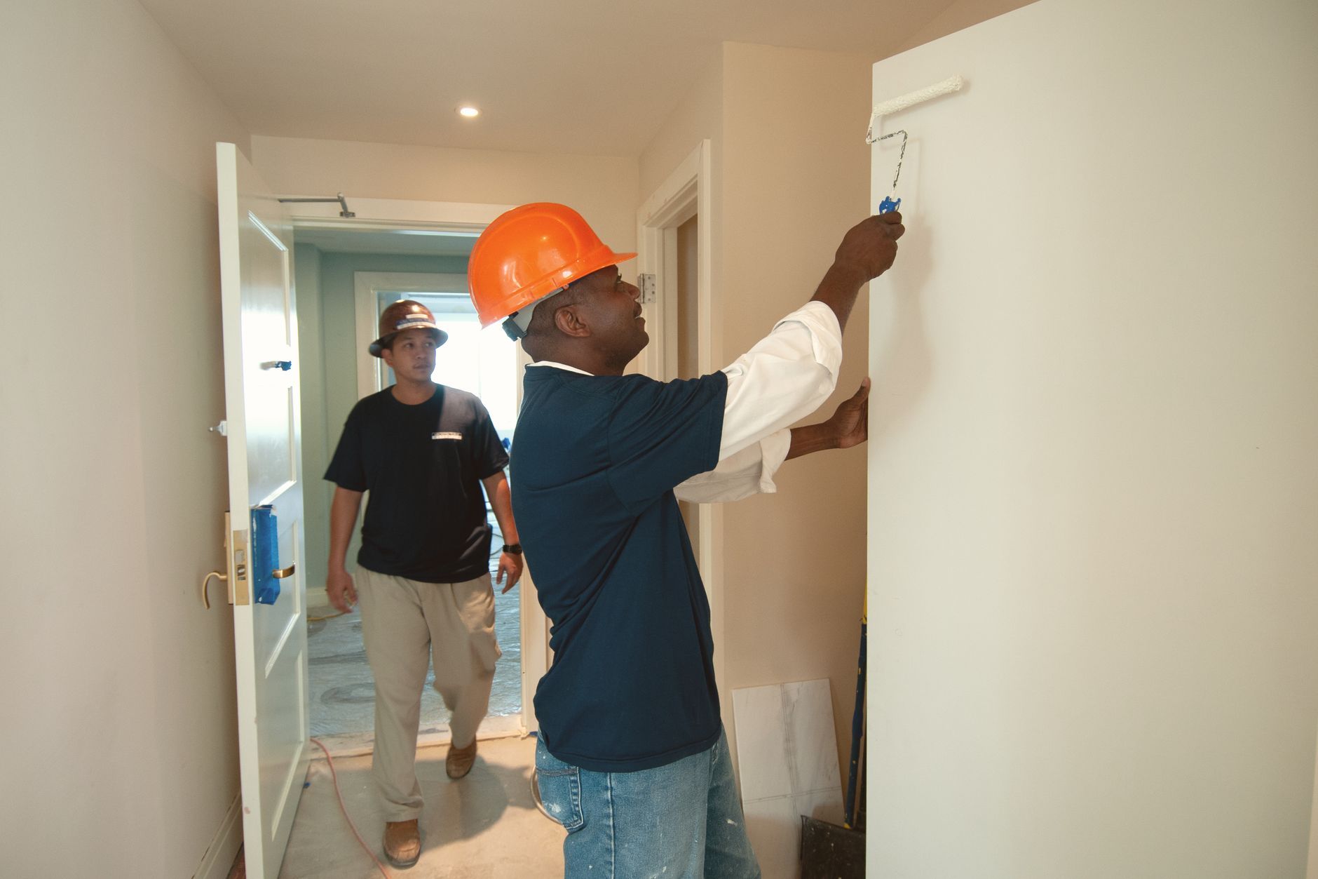 Professional commercial painting contractor in safety gear reviewing a detailed checklist on a clipboard while standing in