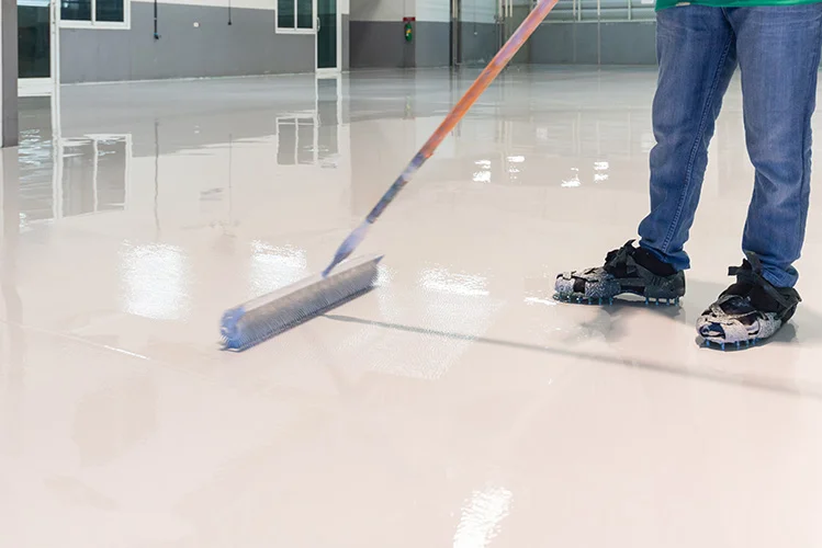 Worker Applying Sealer as Top Coat Over Epoxy Floor