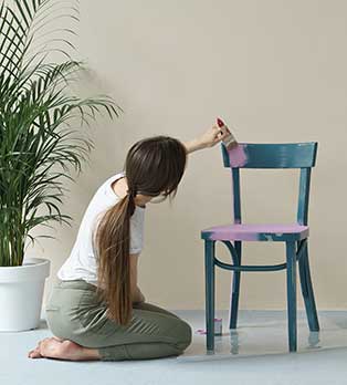 What Types of Brush Are Best for Painting Furniture? - Woman Painting a Chair