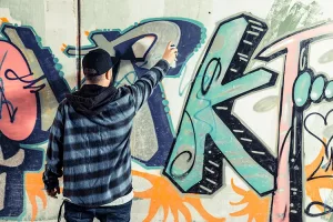Man Spraying Graffiti on Walls